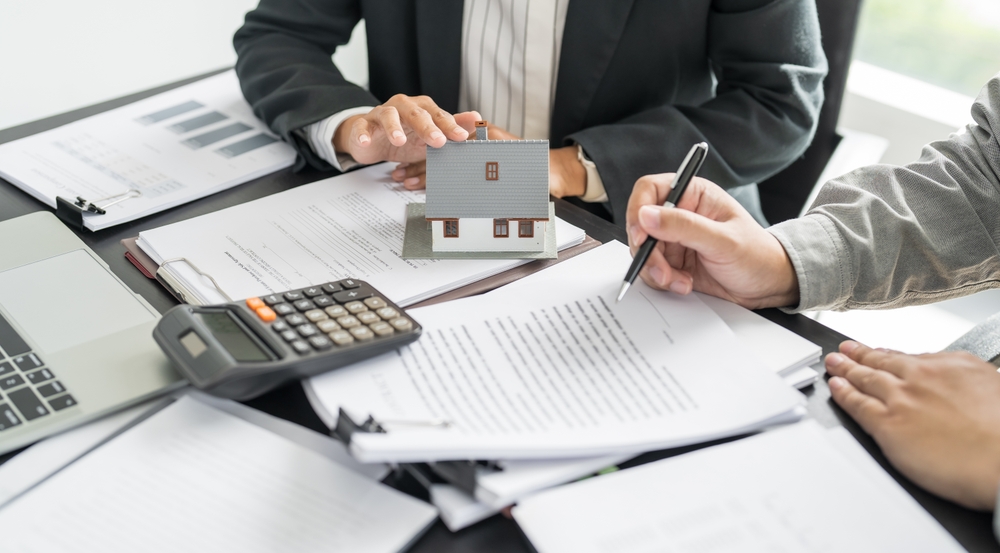 Preparing documents for signing a sale and purchase agreement, an important step for foreigners buying property in Thailand.