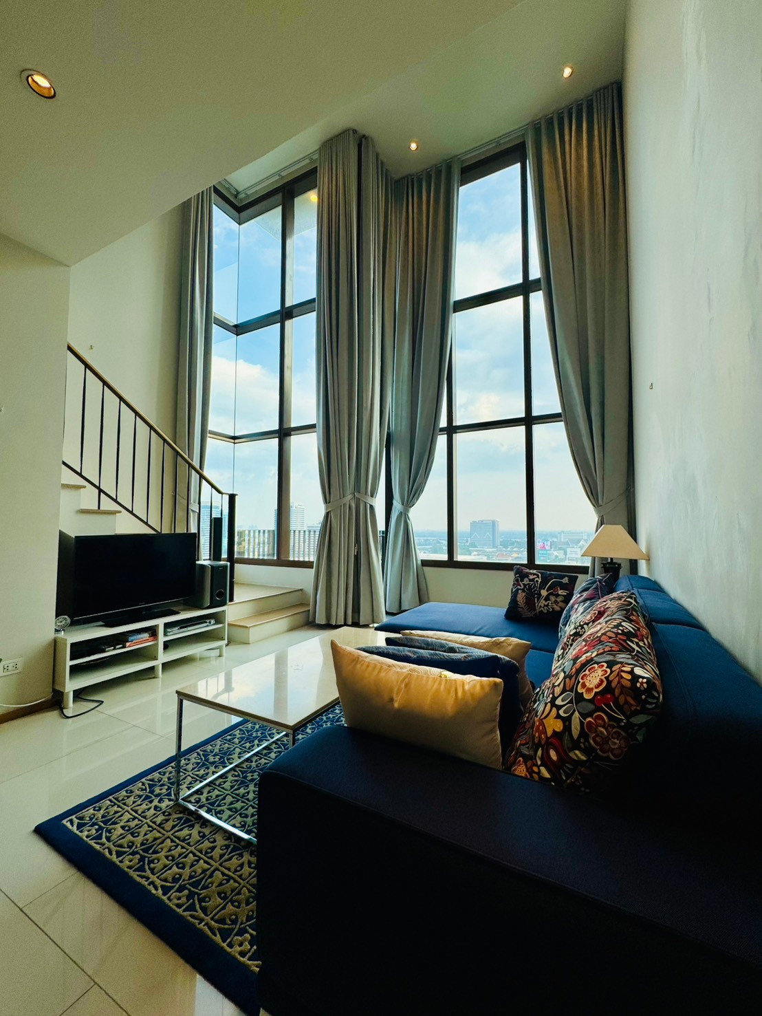 The Emporio Place, a 2-story duplex room with a mezzanine, a spacious room with a bathtub. and a balcony with city views, 1 bedroom, 2 bathrooms