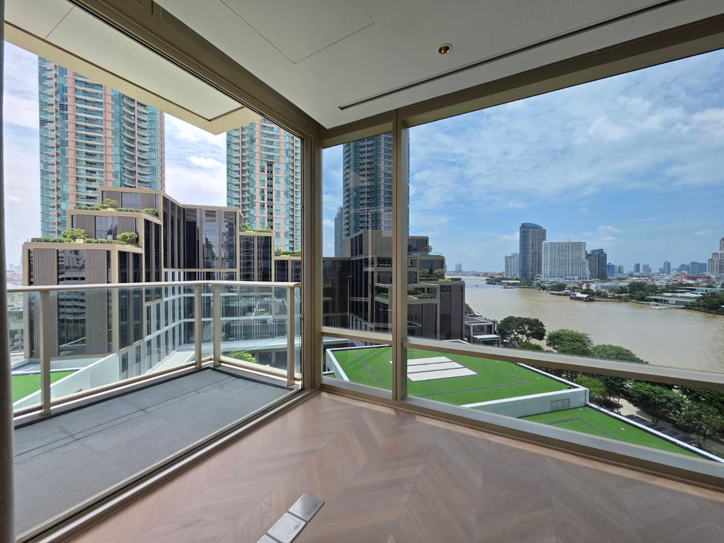 One-bedroom full-front views of the Chao Phraya River and cityscape through expansive floor-to-ceiling glass walls from every living space. One-bedroom full-front views of the Chao Phraya River and cityscape through expansive floor-to-ceiling glass walls from every living space.