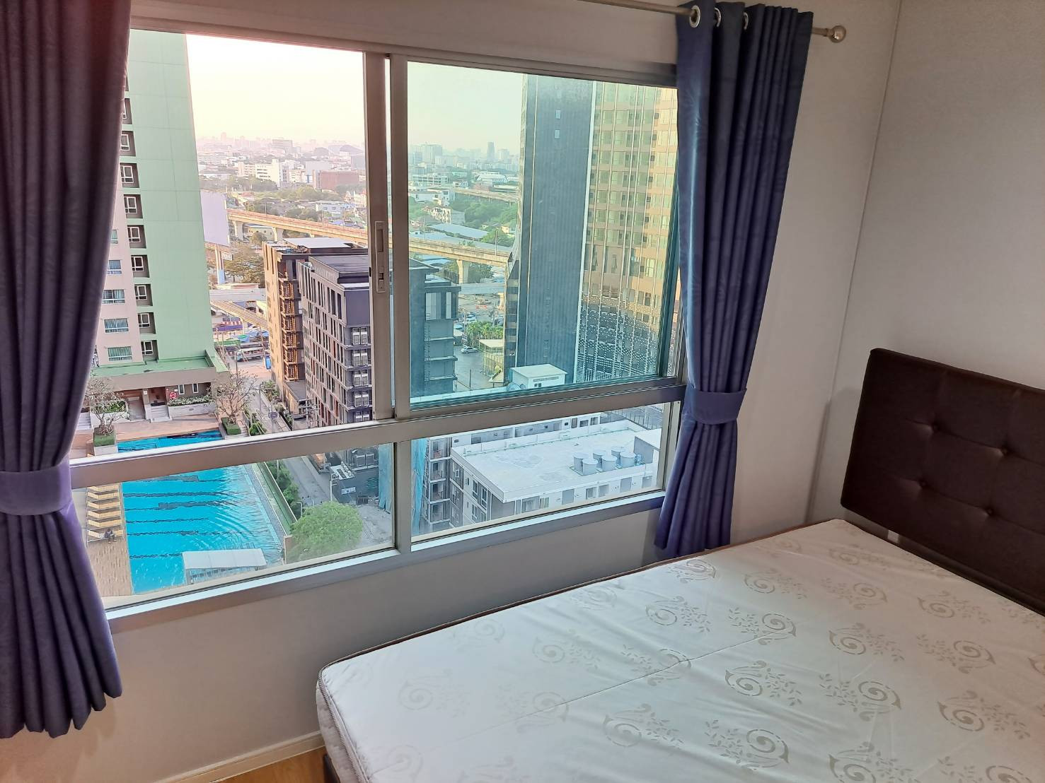 Condo for rent at Lumpini Place Srinakarin-Hua Mak: Corner unit with pool view, located near two train lines (Hua Mak Station) and just 10 minutes from Stamford University.
